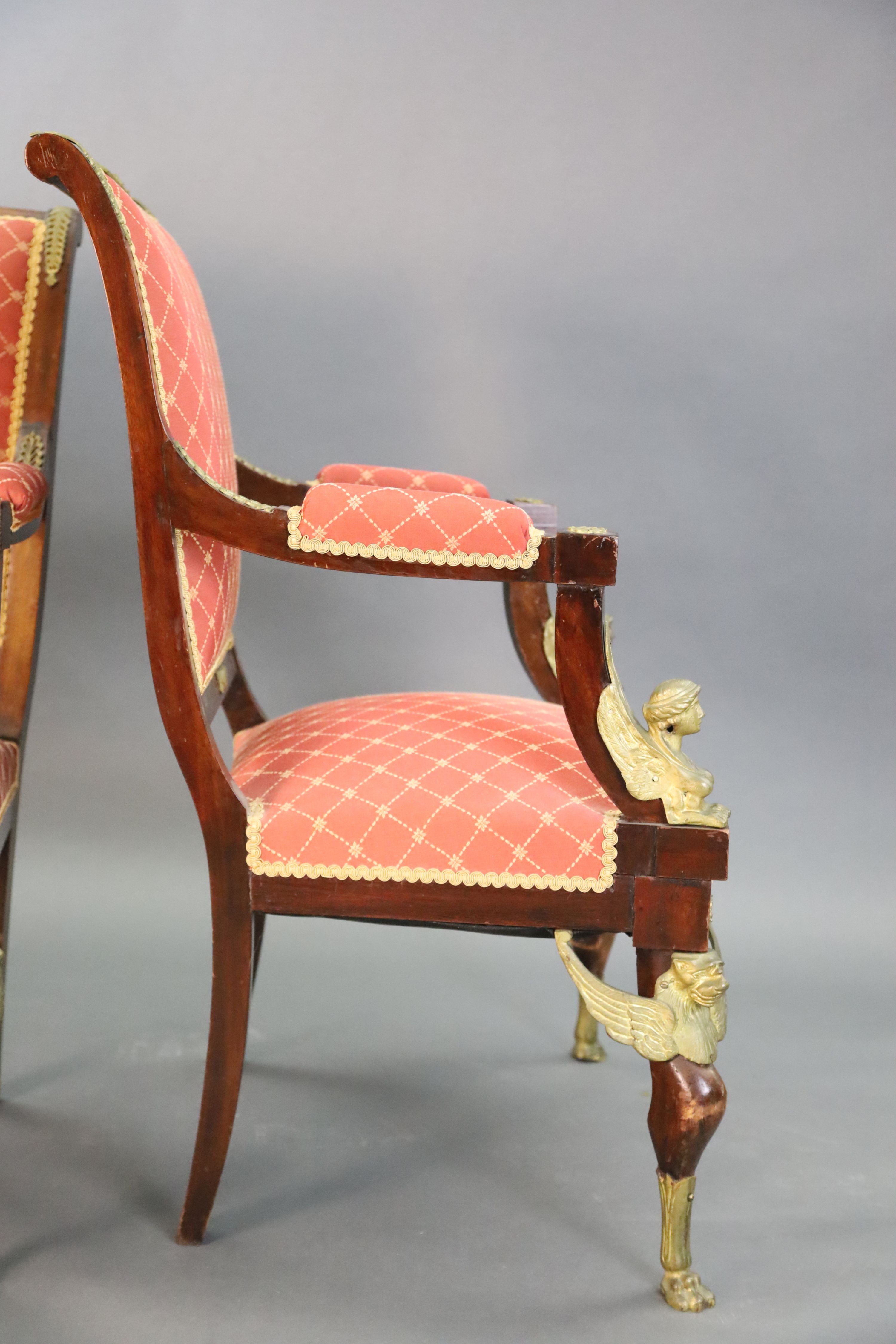 A late 19th century French Empire style ormolu mounted mahogany three piece salon suite, settee W.4ft 7in. D.2ft 5in. H.3ft 6in.